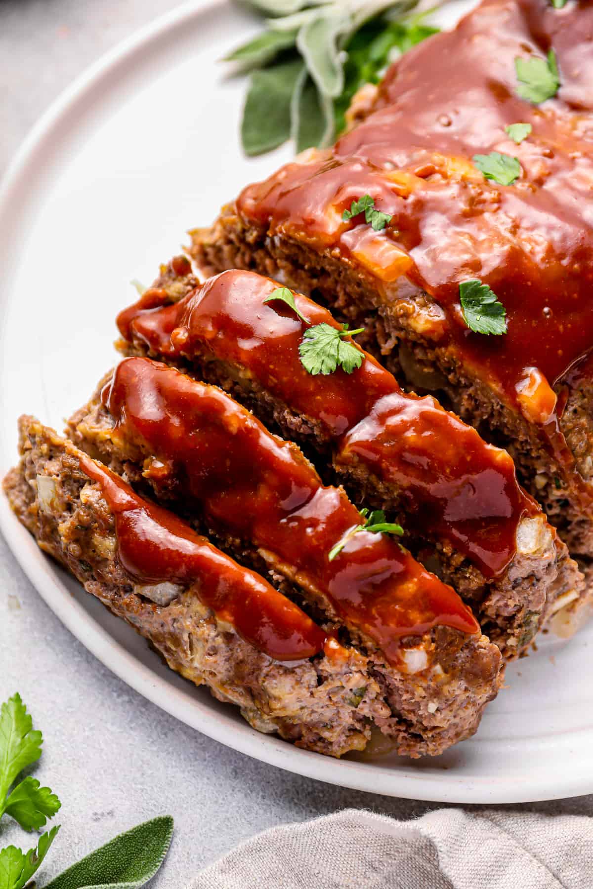 sliced instant pot meatloaf on a white serving plate.