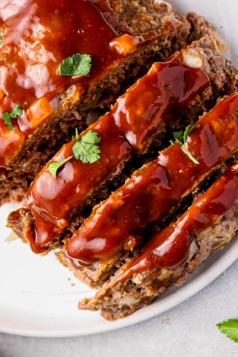 close up of sliced instant pot meatloaf on a white serving plate.