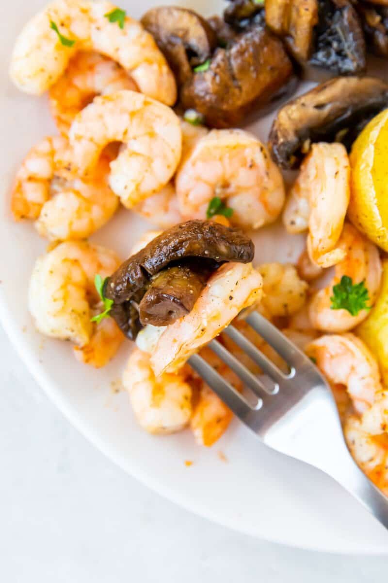 a forkful of air fryer garlic shrimp and mushroom.