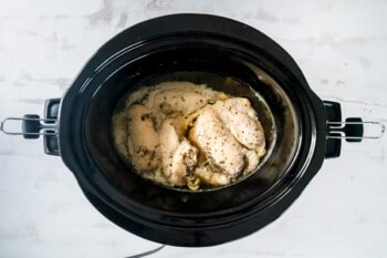 cooked chicken breasts in a crockpot.