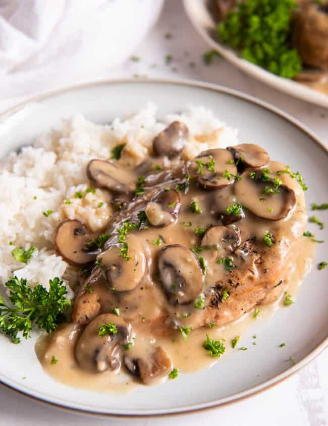 crockpot chicken marsala with white rice on a white plate.