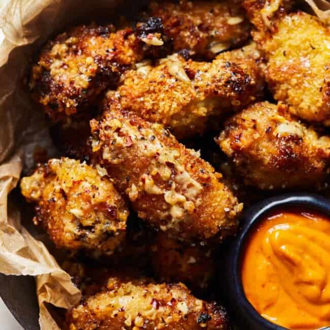 a basket of crockpot wings with sauce