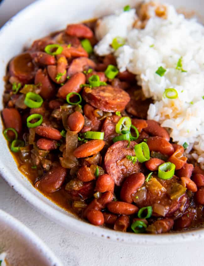 close up of crockpot red beans and rice in a white bowl.