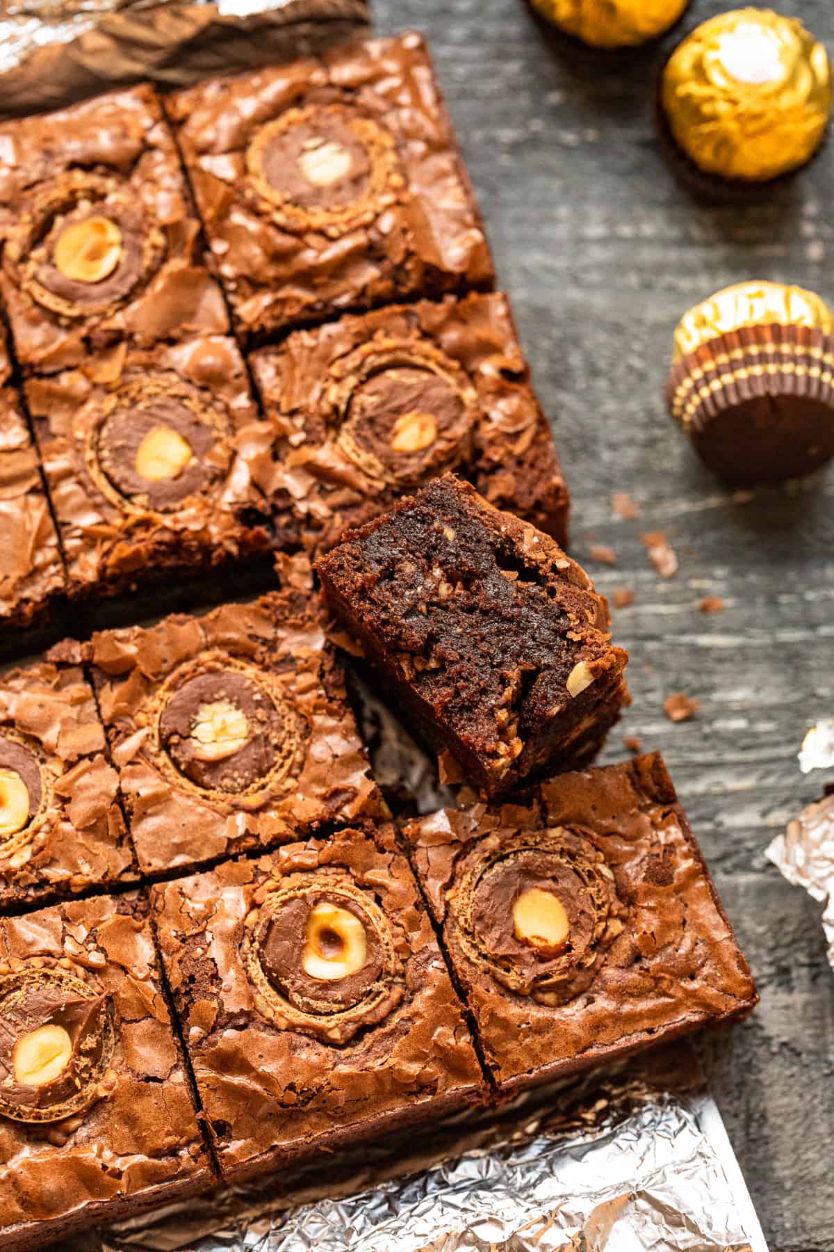 upturned ferrero rocher brownie leaning against cut ferrero rocher brownies.