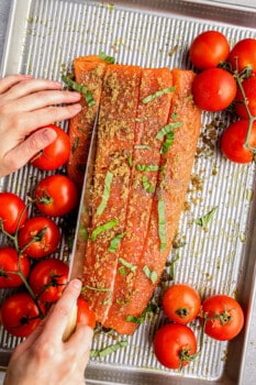 cutting slits into salmon to stuff