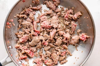 pork cooking in a frying pan.