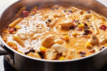 chicken alfredo pasta cooking a skillet