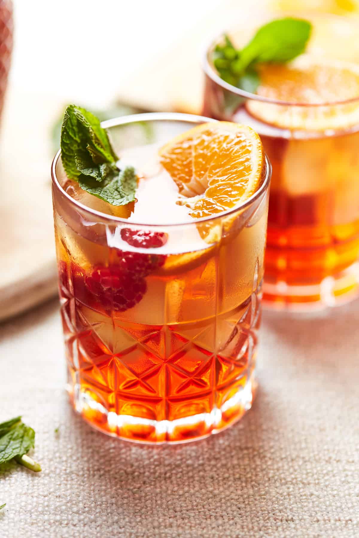 a glass of raspberry spiked tea