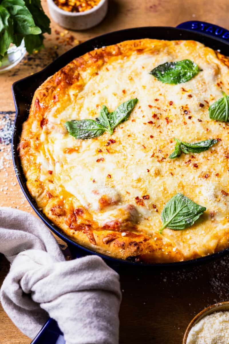 cheesy pizza in a cast iron skillet