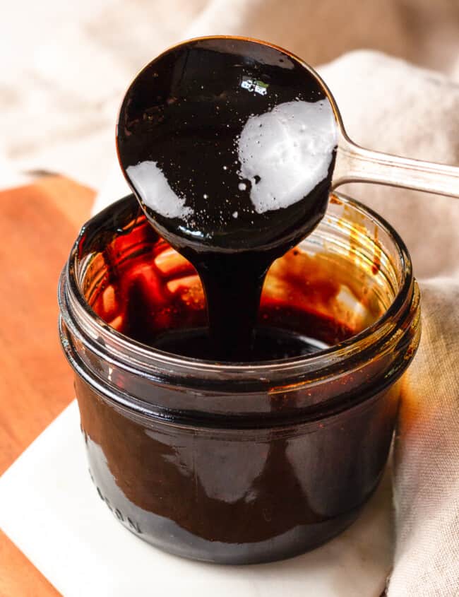 jar of balsamic glaze, spoon dipping into it