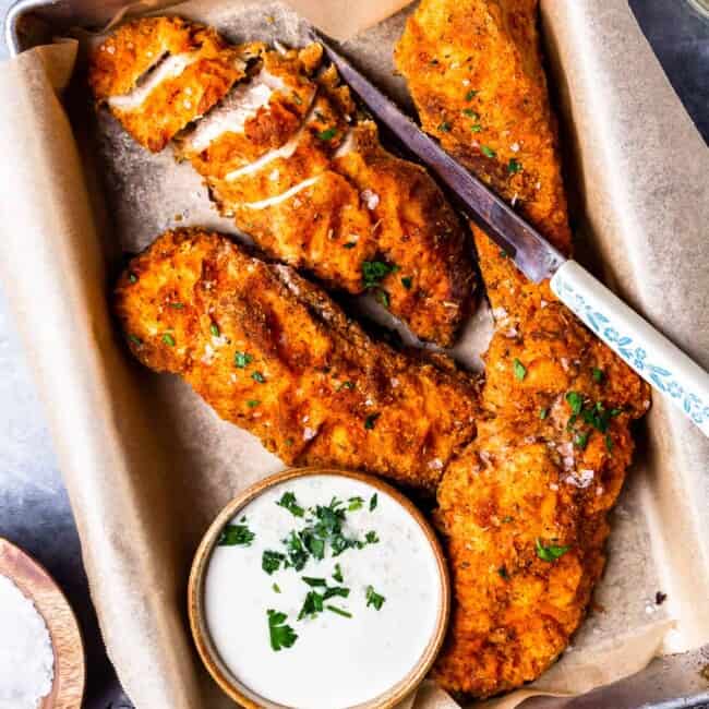 four pieces of oven fried chicken on a tray