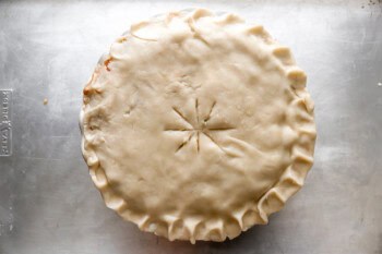 a pie crust with vent slits cut in the top over a pie plate.