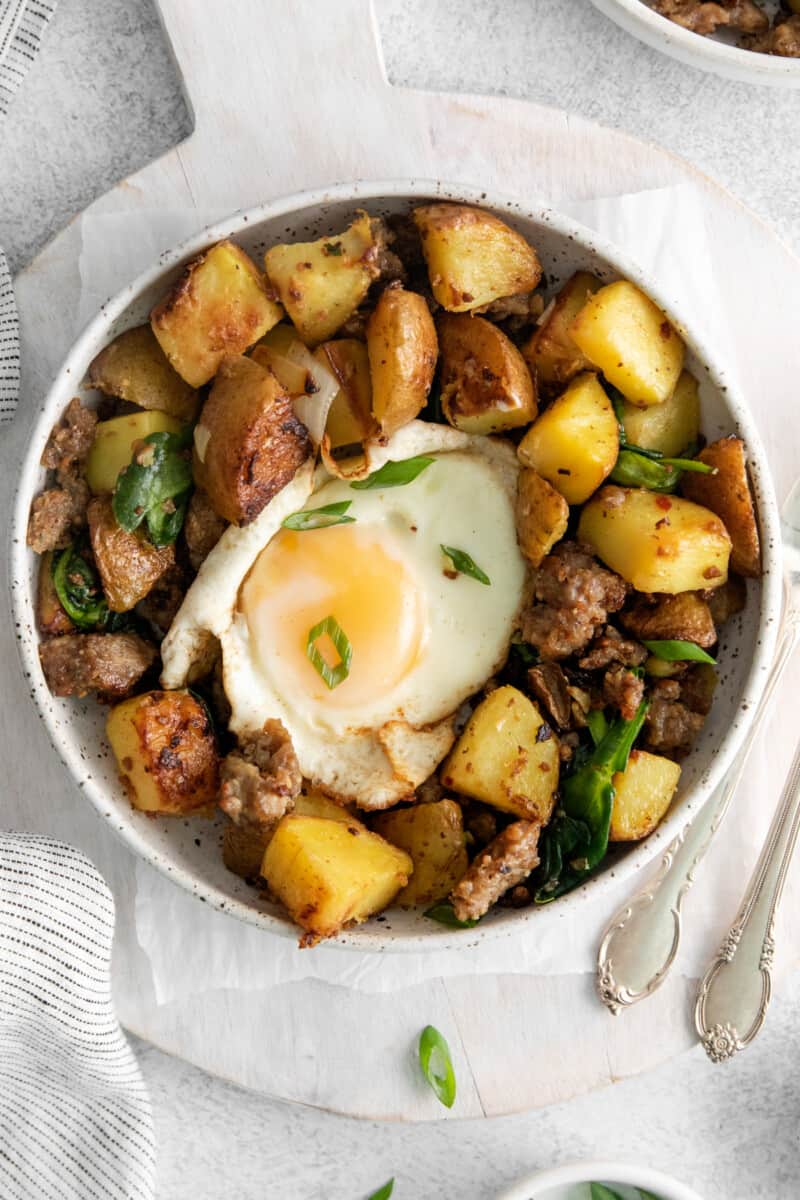 overhead view of breakfast hash in a white bowl.