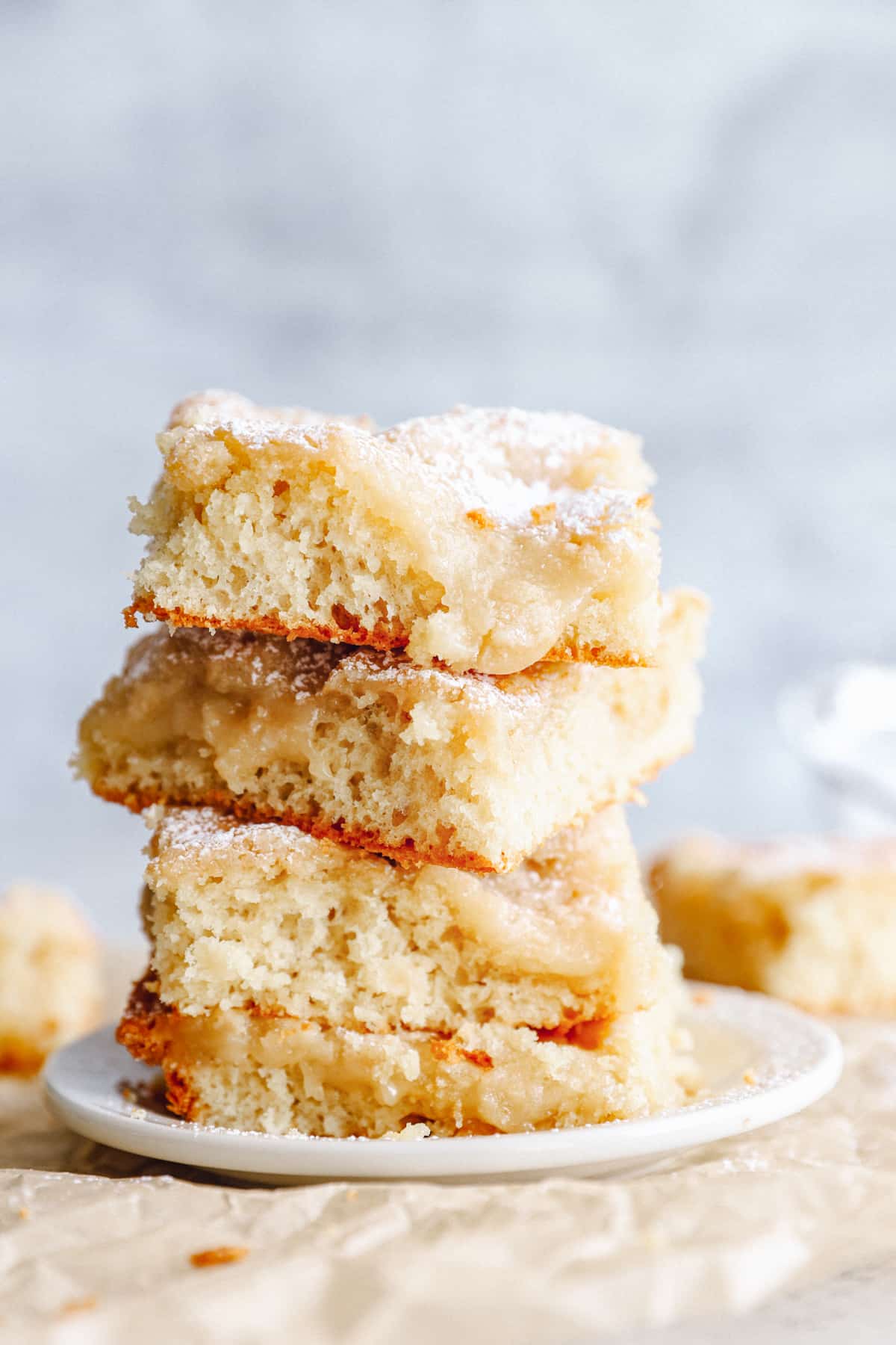 squares of gooey butter cake stacked up on top of each other