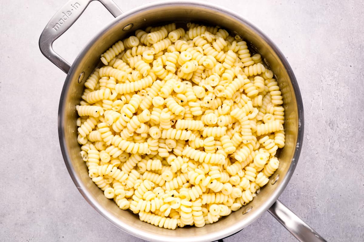 cacio e pepe in a stainless steel pan.