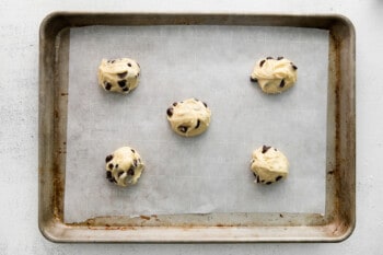 5 cake mix chocolate chip cookie dough balls on a baking sheet.