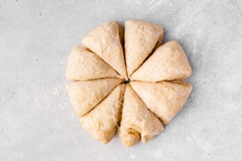 pillowy naan dough sliced into sections