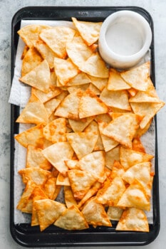 homemade tortilla chips on a cutting board.