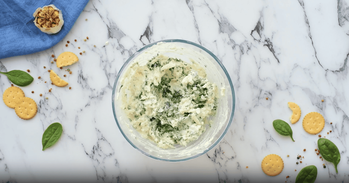 spinach dip ingredients in a glass bowl.