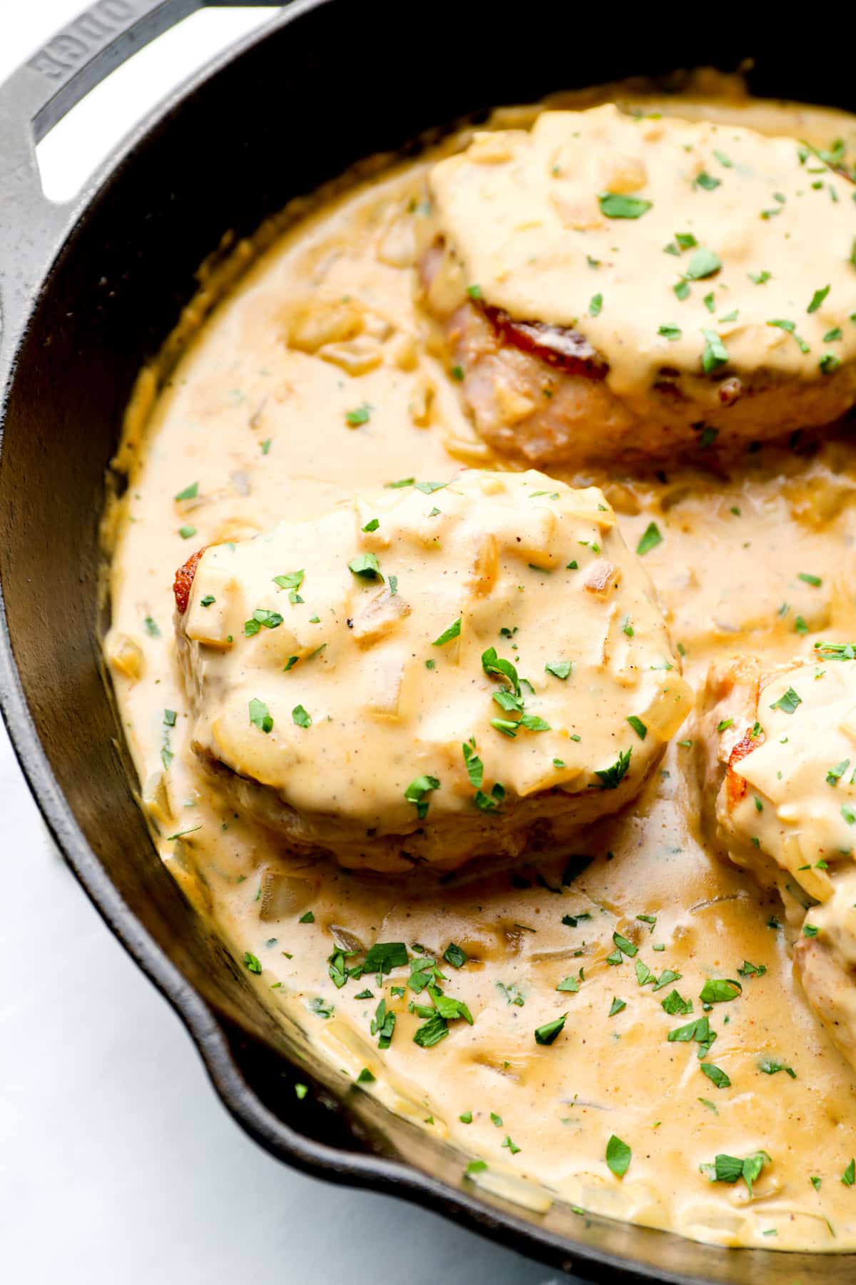 gravy smothered pork chops in a skillet