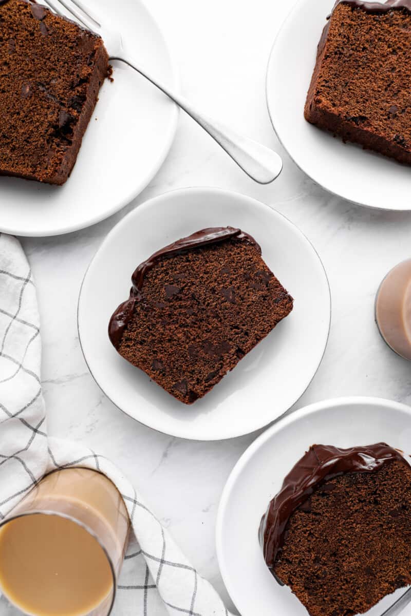 overhead view of slices of chocolate pound cake on white plates.