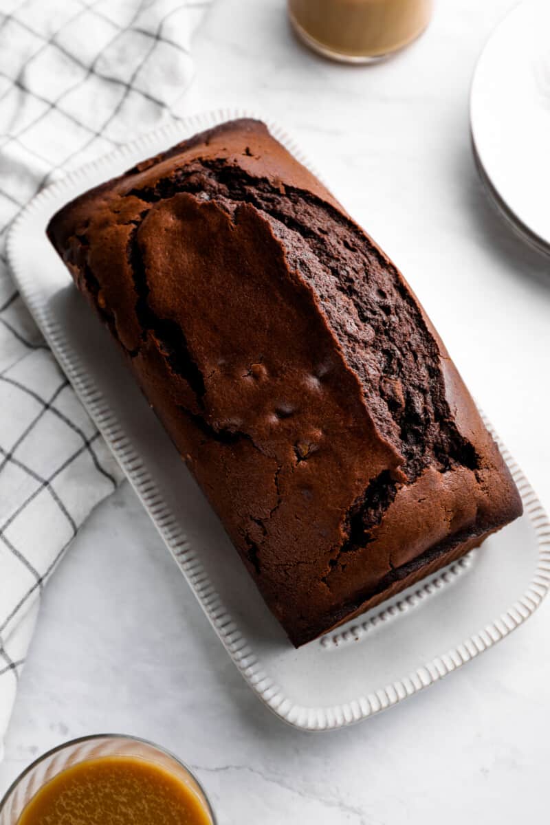 chocolate pound cake on a white serving plate.