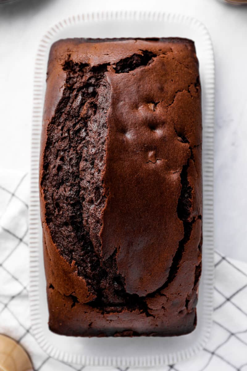 overhead view of chocolate pound cake on a white serving plate.