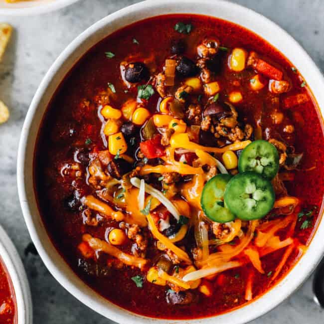 close up of crockpot taco soup in a white bowl.