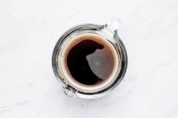 overhead view of coffee in a liquid measuring cup.