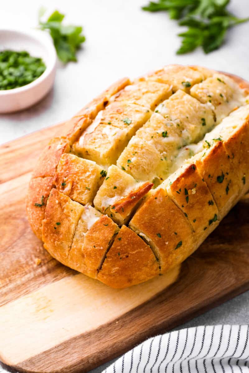 pull apart cheese bread on a wooden cutting board.