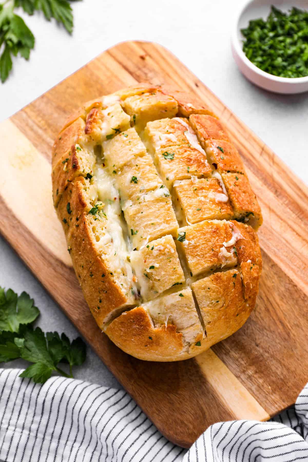 pull apart cheese bread on a wooden cutting board.