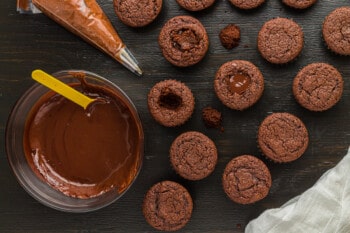 filling chocolate cupcakes with ganache