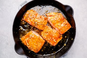 salmon cooking in a skillet