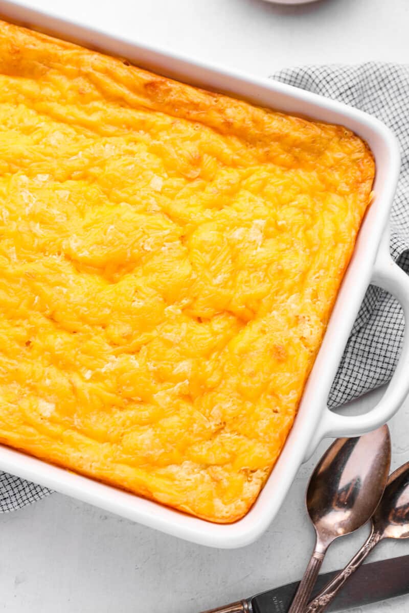 corn casserole in a white baking dish.