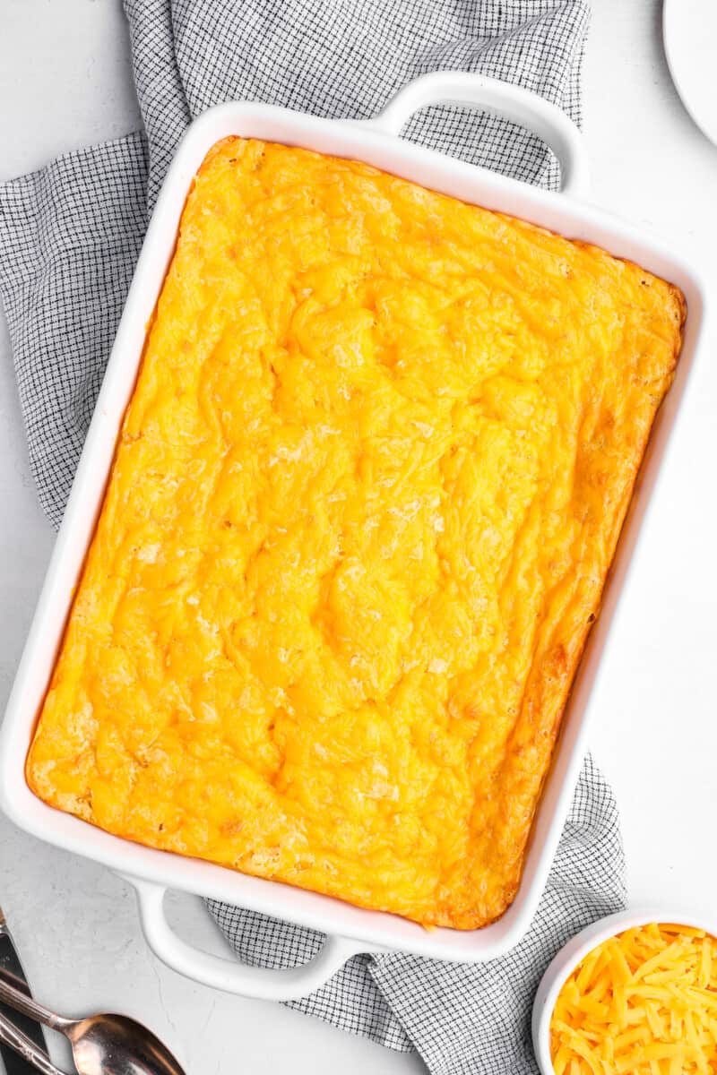 overhead view of corn casserole in a white baking dish.