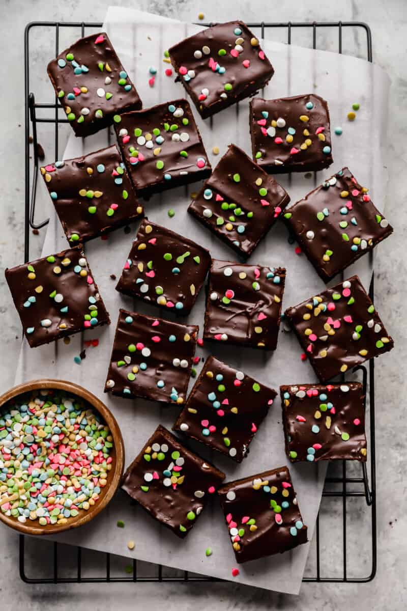 scattered cosmic brownies on a parchment lined wire rack.