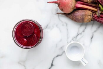 pickled beets in a wide mouth glass jar.