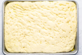 focaccia dough in a baking sheet