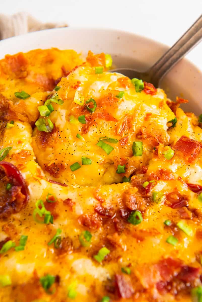 close up on a serving spoon scooping out a serving of casserole