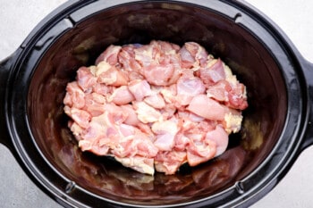 raw chicken thighs in a crockpot.