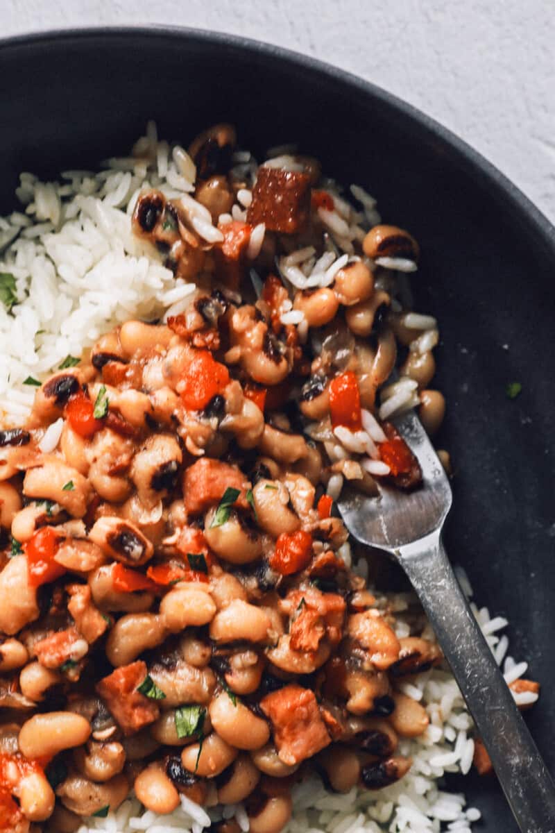 close up on a bowl of black eyed peas with rice