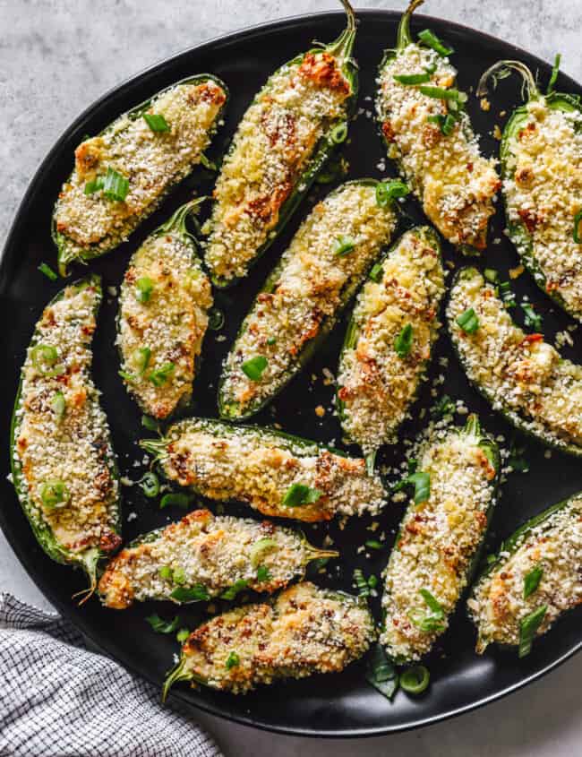 a skillet full of stuffed jalapeño poppers