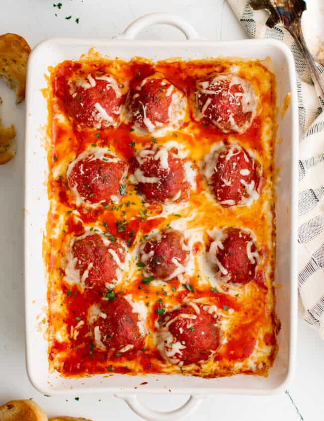 overhead view of meatball casserole in a white baking pan.