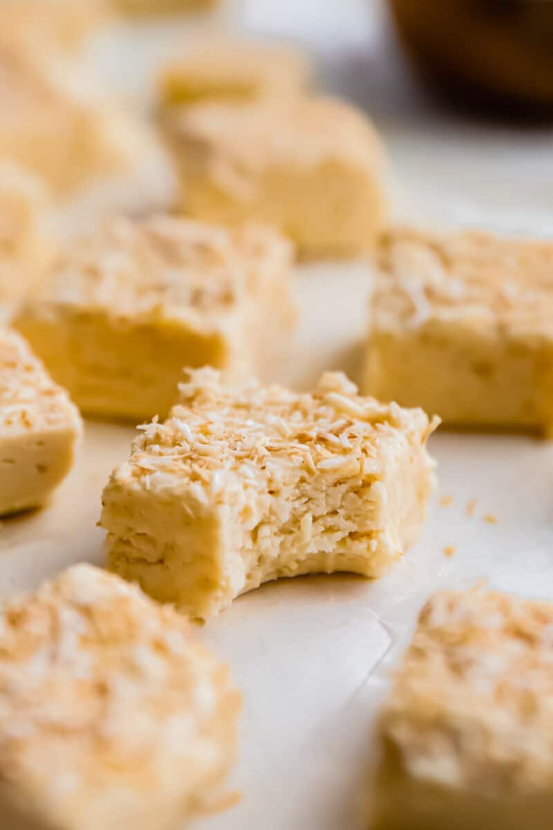 a bitten piece of coconut fudge surrounded by pieces of fudge.