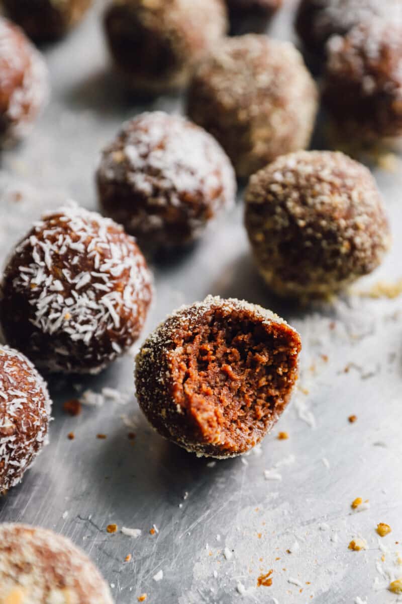 a bitten rum ball in a row of rum balls.