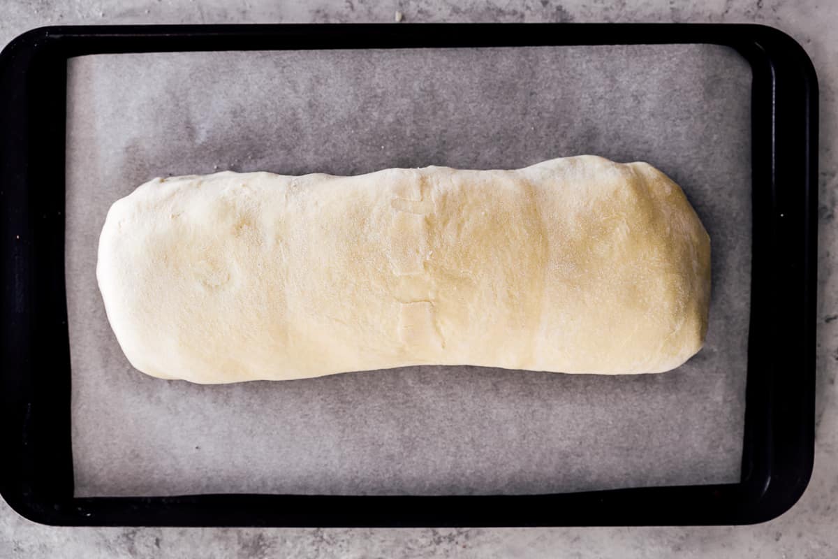 unbaked beef wellington on a baking sheet.