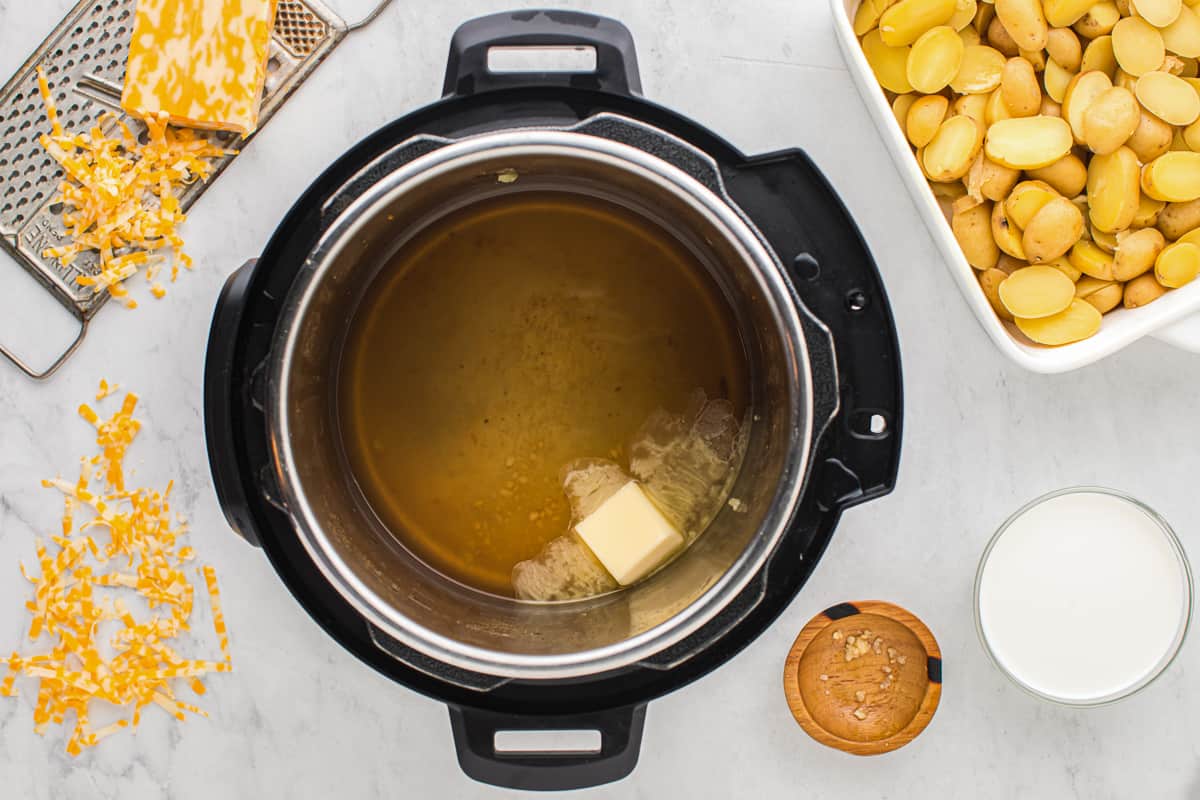 butter melting in an instant pot with garlic.