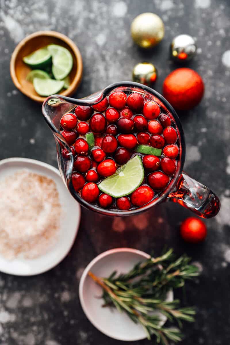 overhead view of jingle juice in a pitcher surrounded by garnishes.