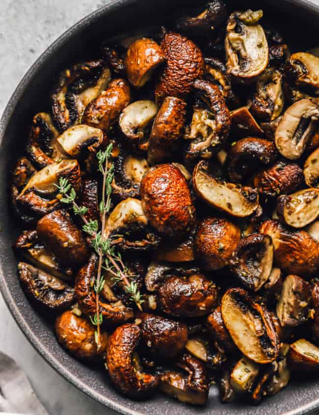 roasted mushrooms in a gray serving bowl.