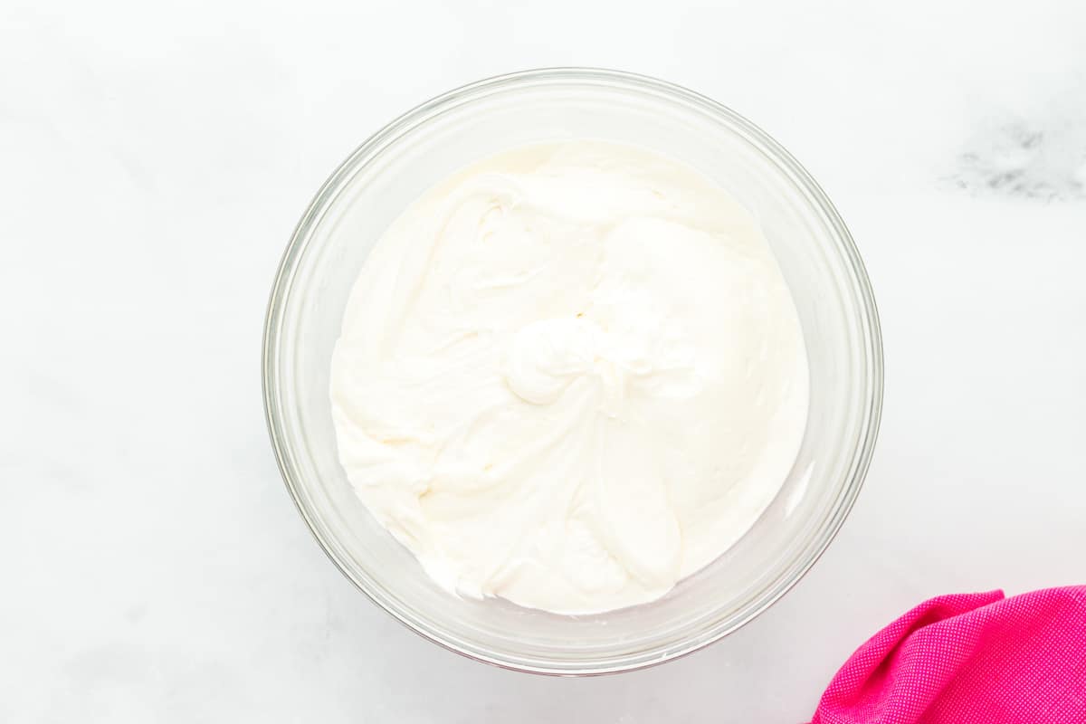 frosting for pink velvet cake in a glass bowl.